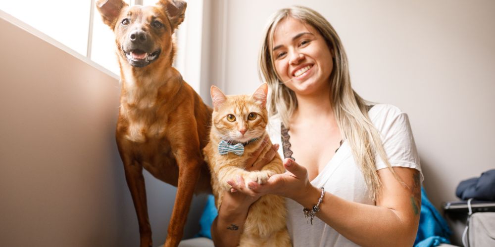 What Happens at a Pet Crematorium - dog and cat with their owner - Companions Haven Ltd